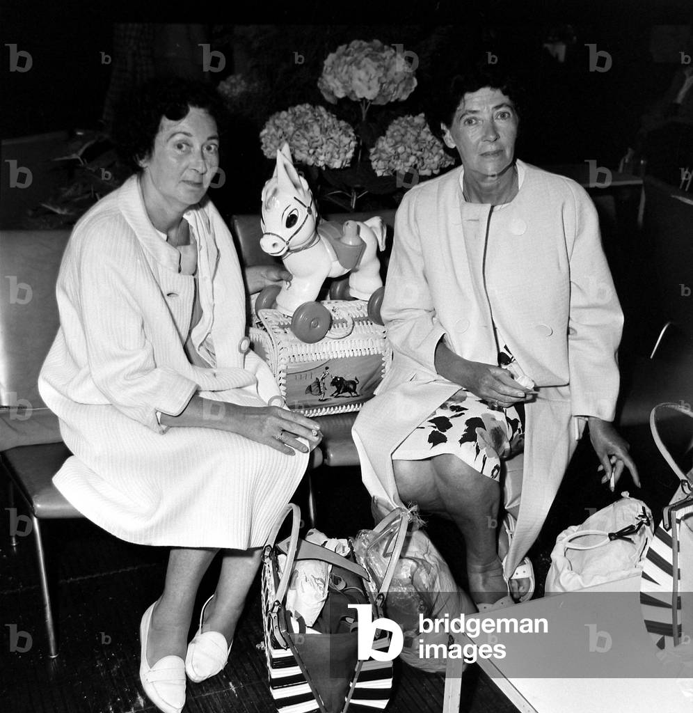 Mrs Margaret Lowen (left) and Mrs Dorothy Cook and they only gift they could afford from their Spanish holiday - a plastic dog
July 1964