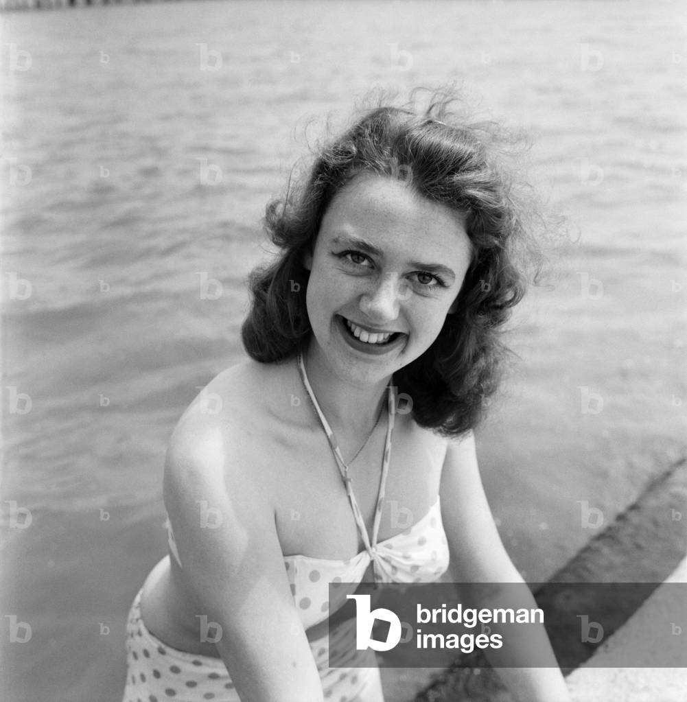 Bathing Girl: Glamour on the Clacton Beach: Pictures of Sherral Mason, 19, a Butlins Red Coat. She comes from Blackpool. June 1960