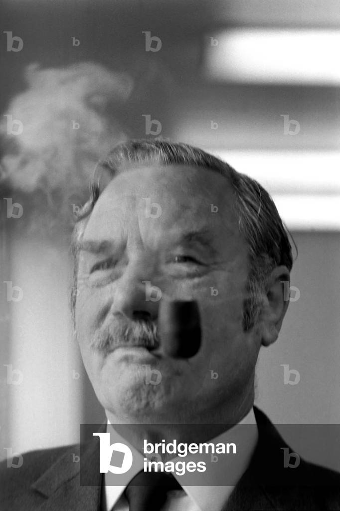 A competitor in the British National Pipe Smoking Championship puffing on his pipe, 6th May 1975 (b/w photo)
