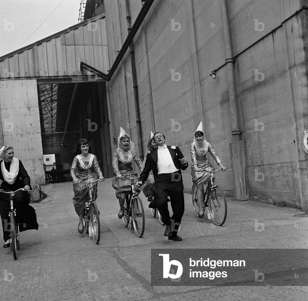 Charles Hawtrey with other members of the cast at Pinewood Studios, April 1959 (b/w photo)
