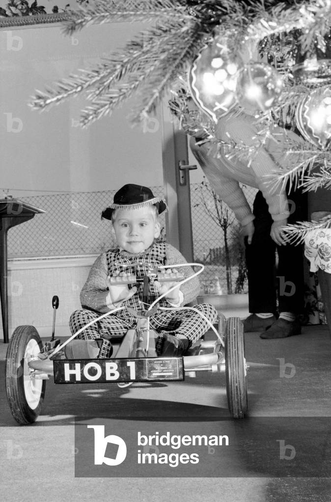 David Smith, a bright three year old from Pattingham, Staffordshire as you can see Santa arrived early this year for David bring a shining new Go Kart. However it is no ordinary Kart but Davids only method of transport for he is a victim of Spina Bifida and has no real use in his legs. The Kart has been specially designed and made by apprentices at a large Wolverhampton, Engineering Factory and was presented to David this week. The Kart which is used by David inside and outside his home is even fitted with a reverse gear. Now Home Office Officials are interested in producing the Kart in Prisons and Borstal Institution and it should sell for approximately £20. December 1969