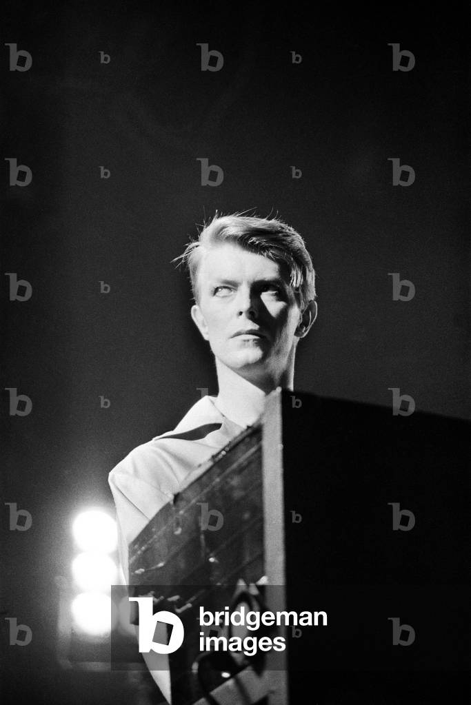 British pop singer David Bowie performing on stage during concert at Wembley, 29th June 1978 (b/w photo)