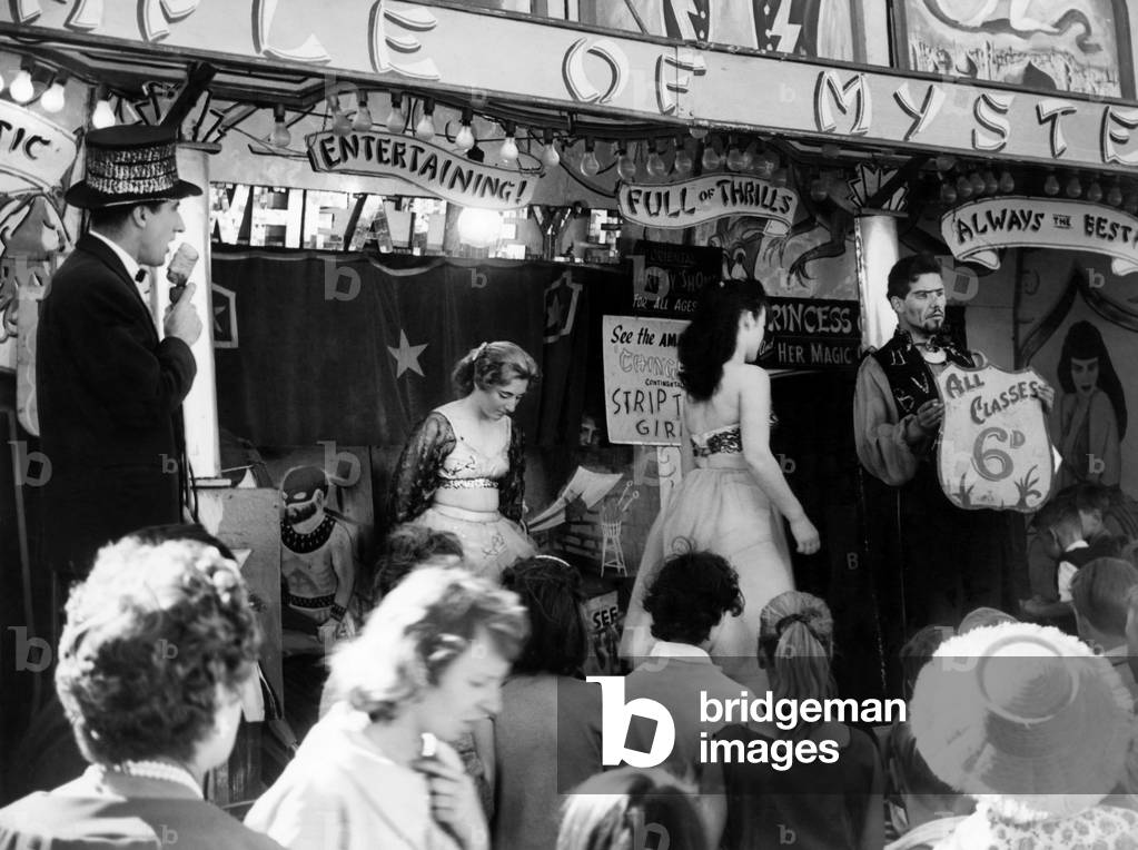 Roll up, Roll up, cries the barker at the Hoppings fair. Held on the Town Moor in Newcastle upon Tyne, Tyne and Wear. 25th June 1960 (b/w photo)