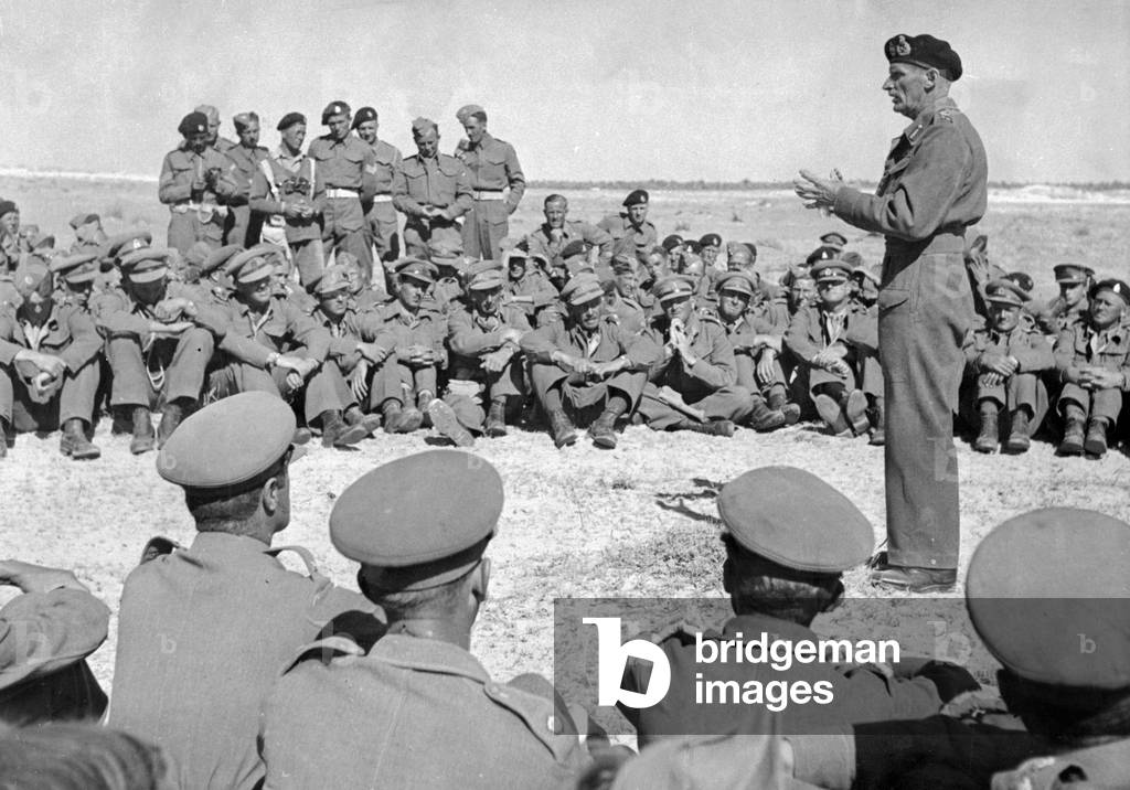 General Montgomery commander of the 8th army congratulating New Zeland and English armoured troops who took part in the great outflanking movement which force the Afrika Corp to abandon the Mareth Line positions. This movement has now become known as 