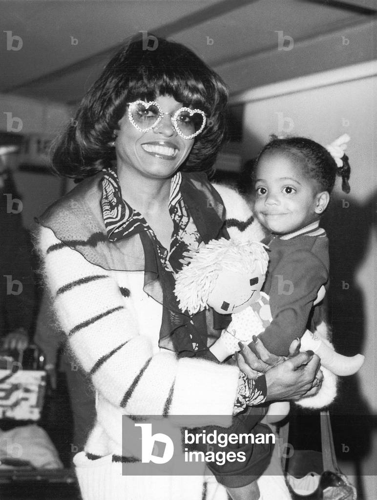 Diana comes to town wearing an eye-catching pair of heart-shaped specs. American Singer Diana Ross, star of the film Lady Sings The Blues, arrives at London's Heathrow Airport on Sunday. Diana, who was accompanied by her two-year old daughter Rhona, is to appear on stage at the famous London Palladium theatre, 03/09/1973 (b/w photo)