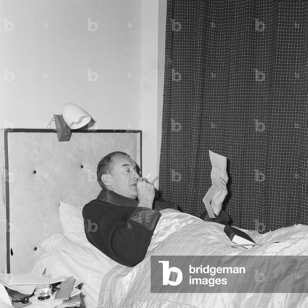Actor George Sanders settles into his makeshift bed at Elstree Studios, where he is currently filming 