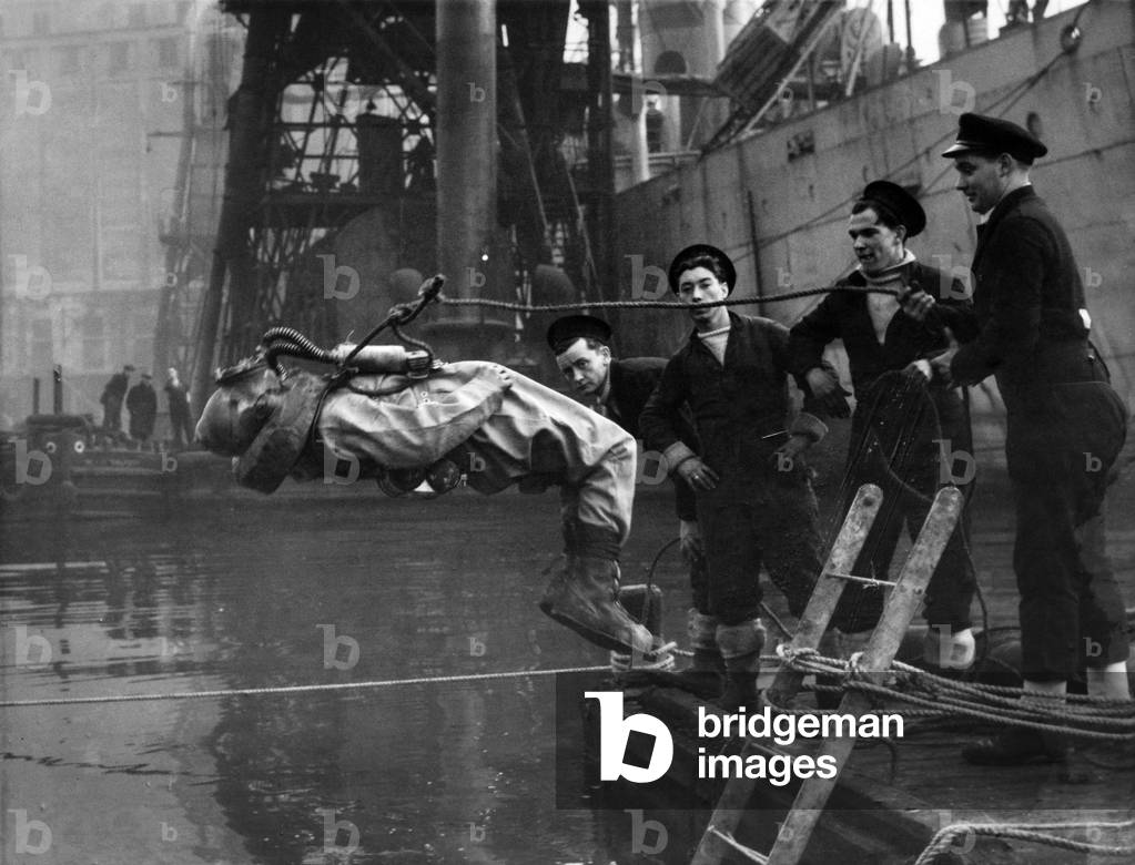 Human Minesweepers who cleared the harbours of Europe from Charburg to Bremen began operations in Manchester Ship canal to locate a bomb which fell there five years ago. 