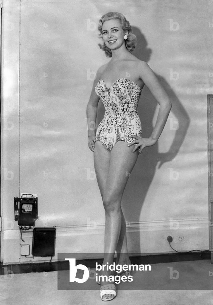 Clothing Beach: Swimming costume. 
Model number 1181 shows printed Rayon Batiste French style unskirted model with cross lacing. August 1956