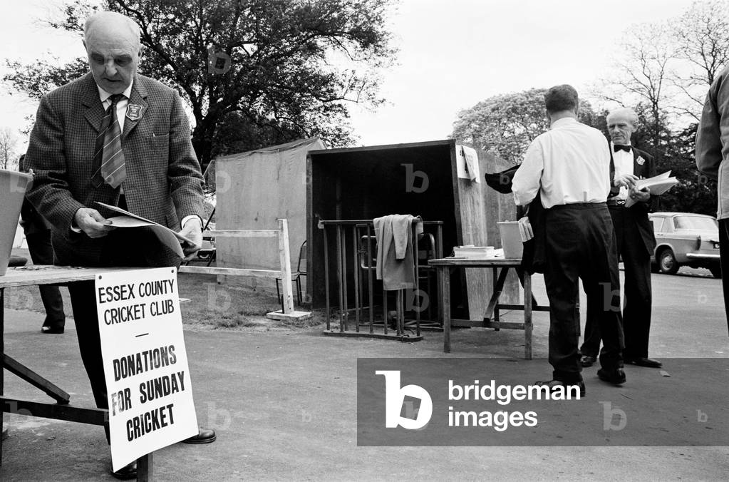 For the first time County cricket was played on a Sunday. The match between Essex and Somerset took place at Valentine's Park in Ilford. Picture shows: No charge for entrance on a Sunday so fans are asked 2/6 for a teamsheet and a contribution in the bucket. 15th May 1966 (b/w photo)