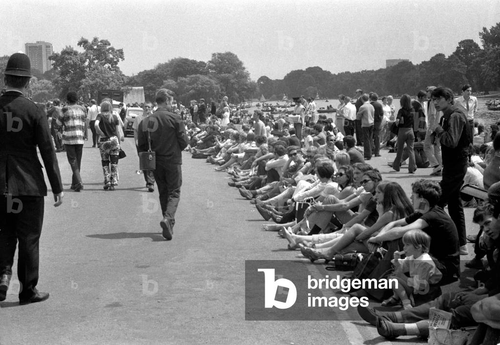 Pop fans sitting down near the Serpentine at The Rolling Stones concert at Hyde Park, 5th July 1969 (b/w photo)