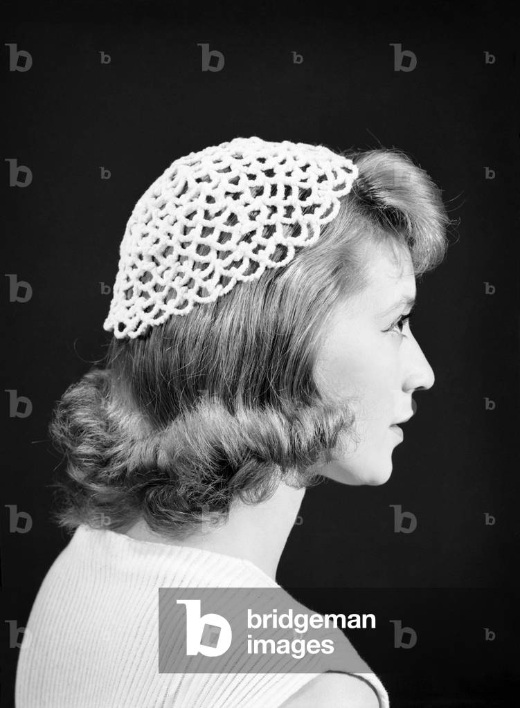 Woman wearing pipe clearner hat, July 1956 (b/w photo)