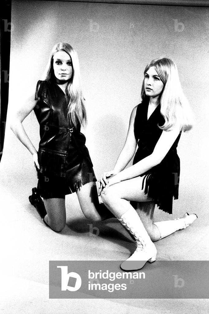 Models wear dresses with knee length boots for a fashion shoot, 13th April 1970 (b/w photo)