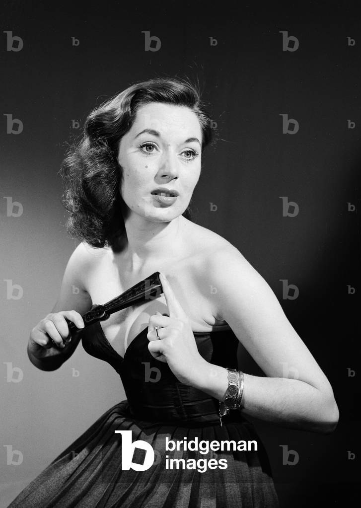 Model with fan in strapless dress. Model with fan in strapless dress., c. 1964 (b/w photo)