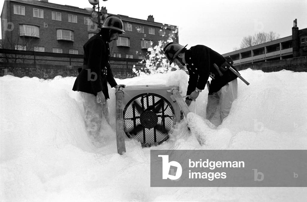London Fire Brigade's new high-exx unit with firemen - Leading fireman Hall and Fireman Looney at Old Street Fire Station, E.C, March 1975 (b/w photo)