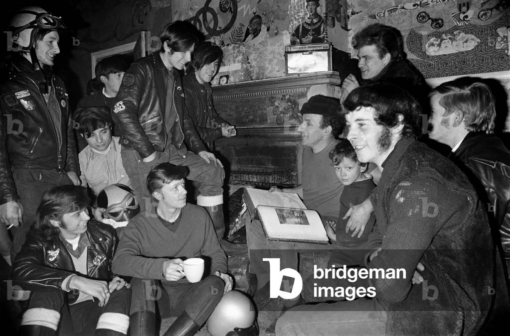 Mr. Ted Wood of Birch, near Manchester reads the Bible to Hell Angels Club during a Community meeting at his home. November 1969