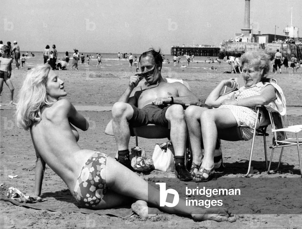 The man couldn't believe his spectacles when he saw topless Vee on a beach while on holiday. 
June 1973