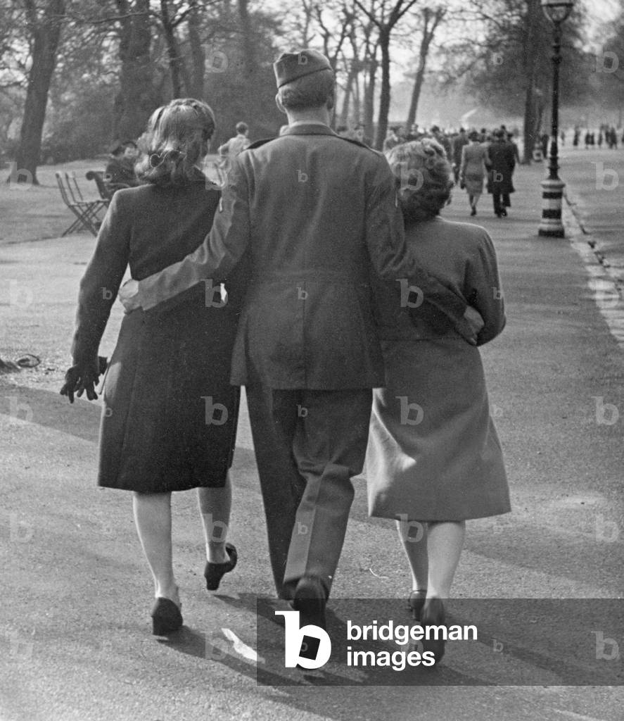 A soldier with a woman on each arm, Easter Parade in Hyde Park, April 9th 1944