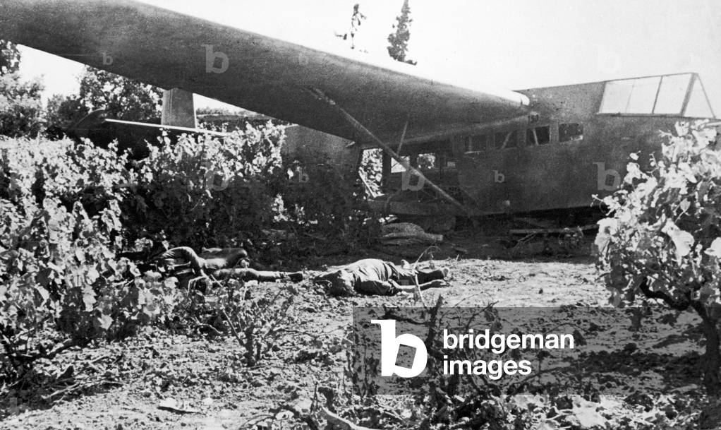 A crashed German glider in Crete and two of the crew lying dead during the Second World War. 26th June 1941 (b/w photo)