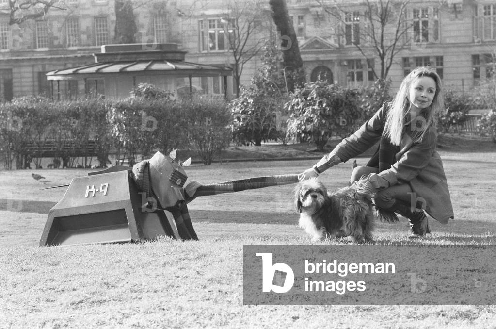 Actress Lalla Ward who will join Dr Who in the long running TV series. Lalla will be the Doctor's 11th girl assistant and the second actress to play the Time Lady Romana (Romanadvoratrelundar) in Doctor Who. After a guest appearance as Princess Astra in the Doctor Who story The Armageddon Factor in 1979, Ward was chosen to replace Mary Tamm, who has decided against continuing in the role. Lalla is seen here posing with K9 the Doctors dog.6th February 1979 (b/w photo)