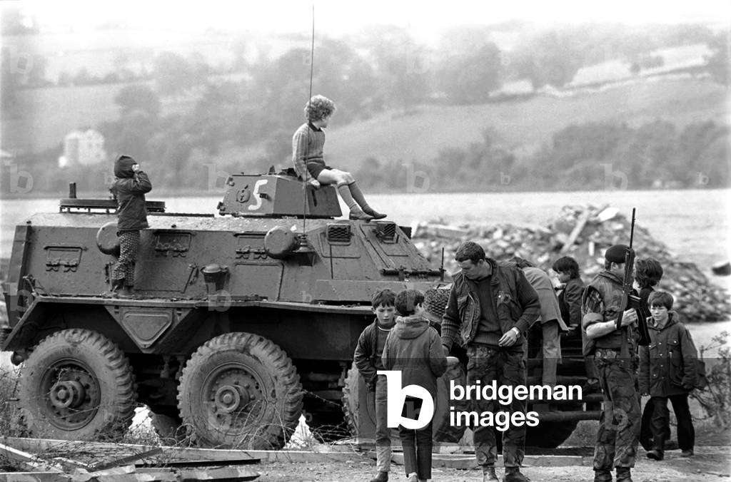 Northern Ireland June 1972. Children and soldiers play at the army base on the Foyle Road. The army were in the process of abandoning the camp. June 1972 72-7009-008