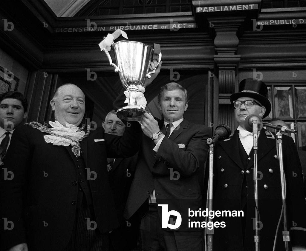 West Ham Captian Bobby Moore shows the European Cup Winners Cup trophy to the crowds from the Town Hall after the victory parade23rd May 1965 (photo)
