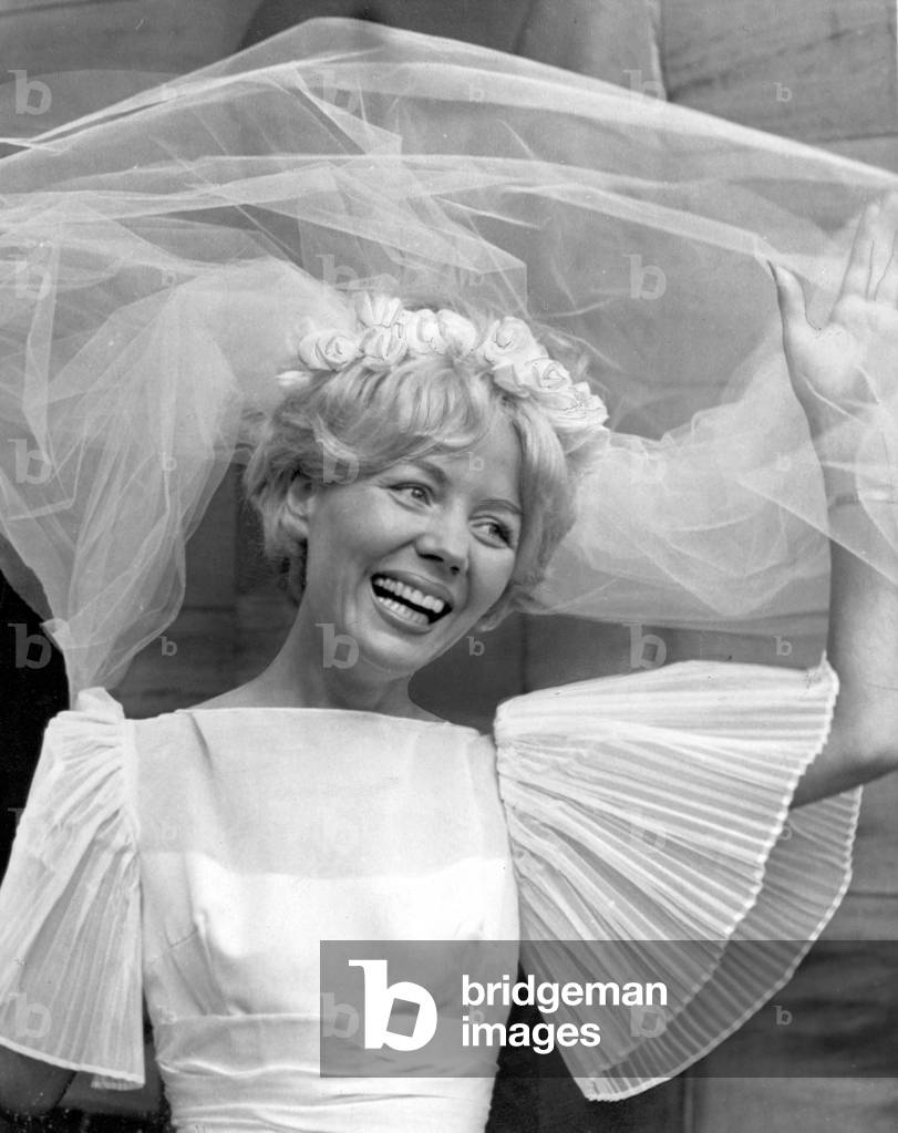 Thirty one year old Babs Beverley of the Beverley Sisters music group pictured on her wedding day in Edinburgh, Scotland. She married dentist Jim Mitchell September 1963 (b/w photo)