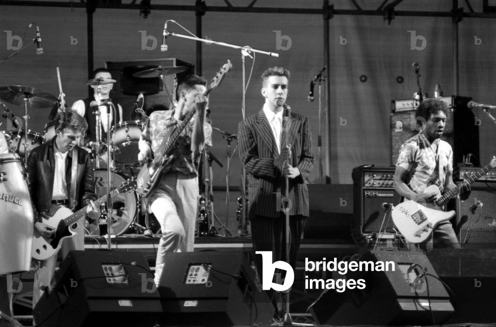 Hazel O'Connor and The Specials performed on stage at the outdoor concert in aid of racial harmony at The Butts stadium in Coventry. Terry Hall singing with The Specials, 22nd June 1981 (b/w photo)
