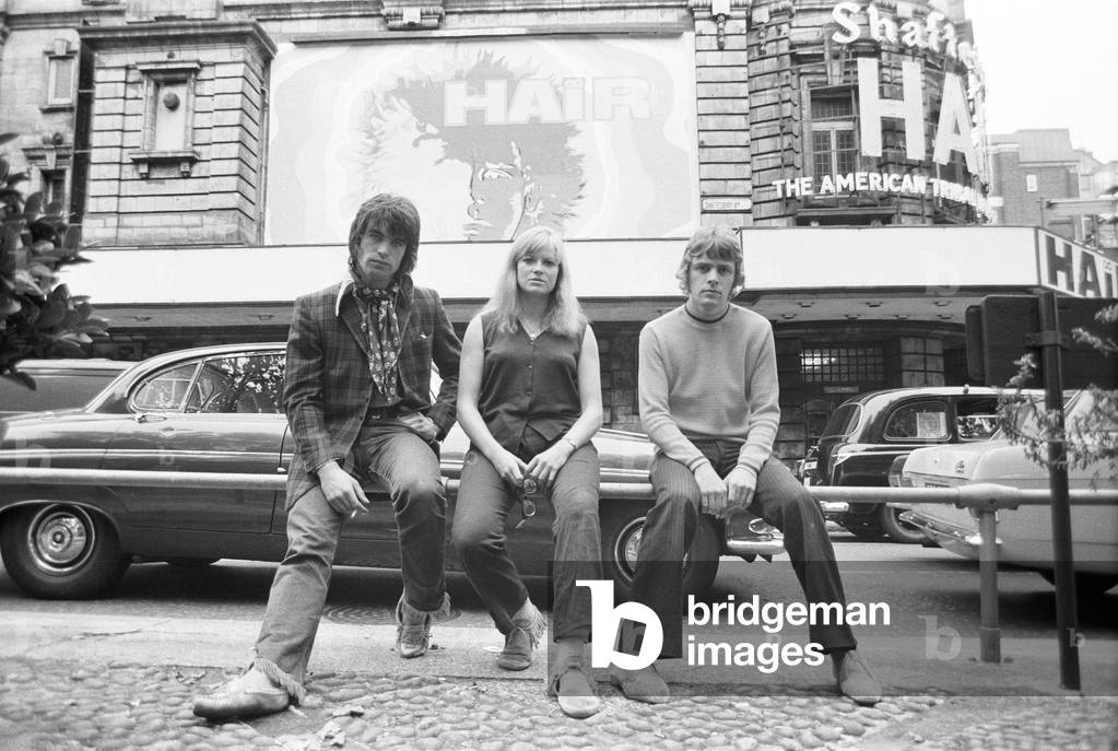 The American play 'Hair' will be opening at the Shaftesbury Theatre soon - rehearsals are now underway there with a cast of 26 boy and girl 'hippies'. Photographed outside the theatre are three of the members of the cast Annabel Leventon (24), Oliver Tobias (20) and Paul Nicholas. 11th September 1968 (b/w photo)