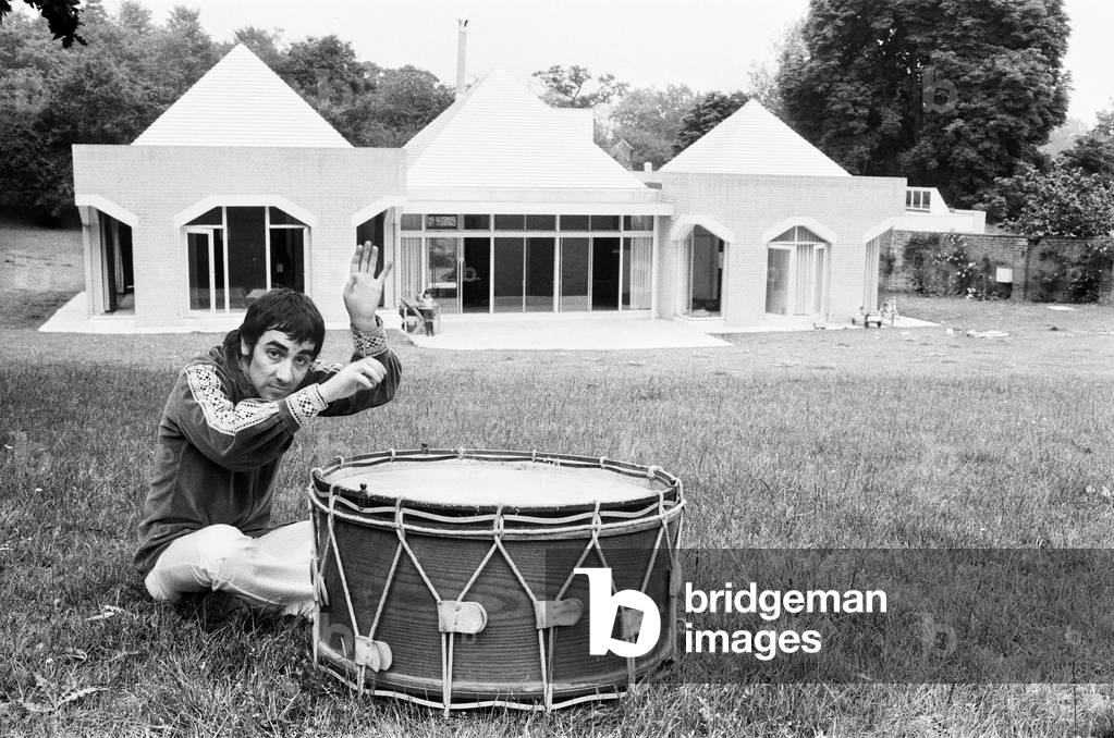 Keith Moon, drummer of The Who rock group, pictured at his new £60,000 home named Tara House in Chertsey, Surrey. 8th July 1971 (b/w photo)