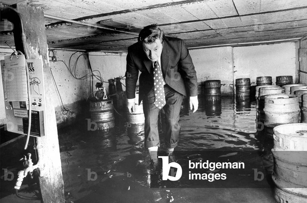 Tenant Cliff Hopton inspects the cellar of The Ship Inn in Durham in 1976 (b/w photo)