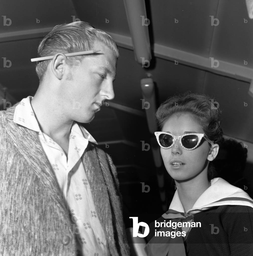 American rock and roll singer Jerry Lee Lewis with his thirteen year old wife Myra at London airport on their way back to the United States. 28th May 1958 (b/w photo)