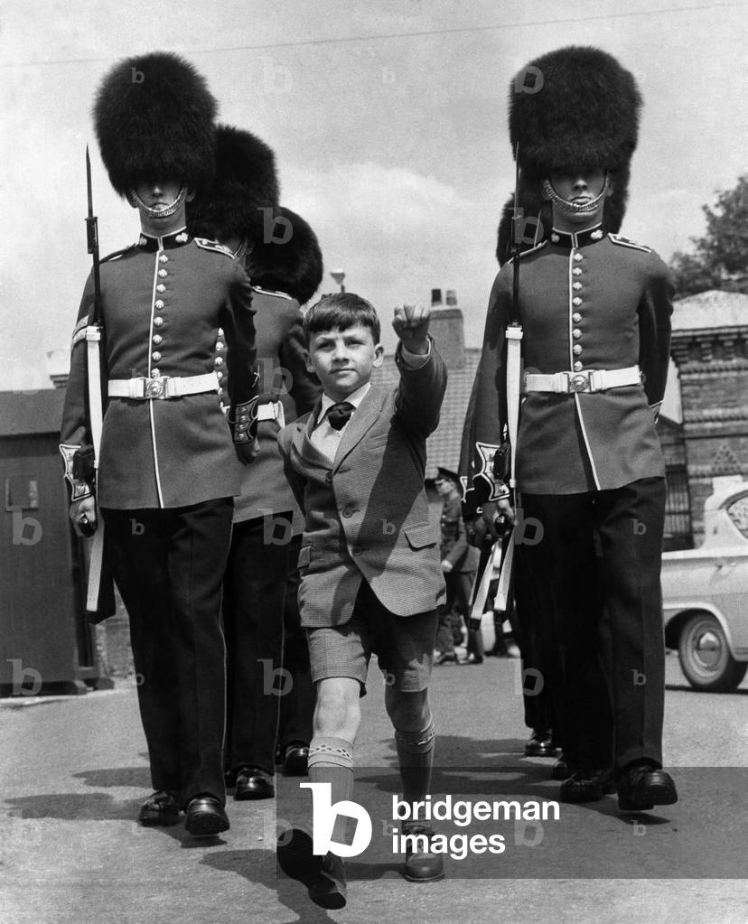 Alexander Morris, a pint-sized 9-year-old with his sights on the army passed his first selection board yesterday. Marching with his back straight as a ramrod, dark-haired Alexander impressed the Chief Constable of Bootle, Lancs Lord Berry and the Guards. May 1962 (b/w photo)