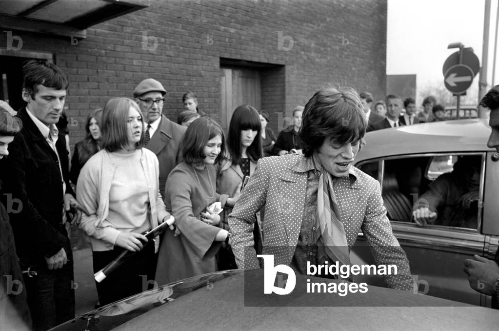 Mick Jagger (the rest of the Rolling Stones, minus Bill Wyman, out of shot) arrive at London Heathrow from Athens. 18 April 1967