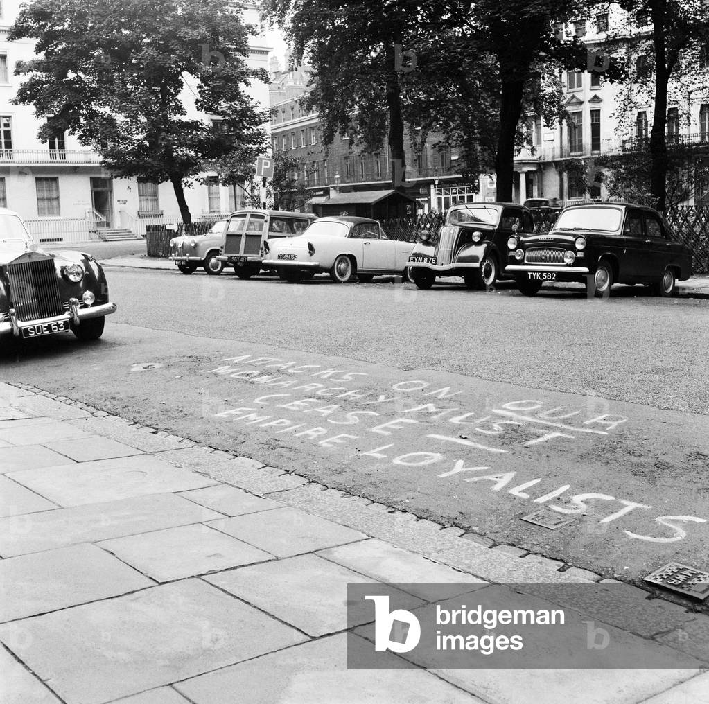 Empire Loyalists paint slogans on homes of the Queen's critics. 18th August 1957 (b/w photo)