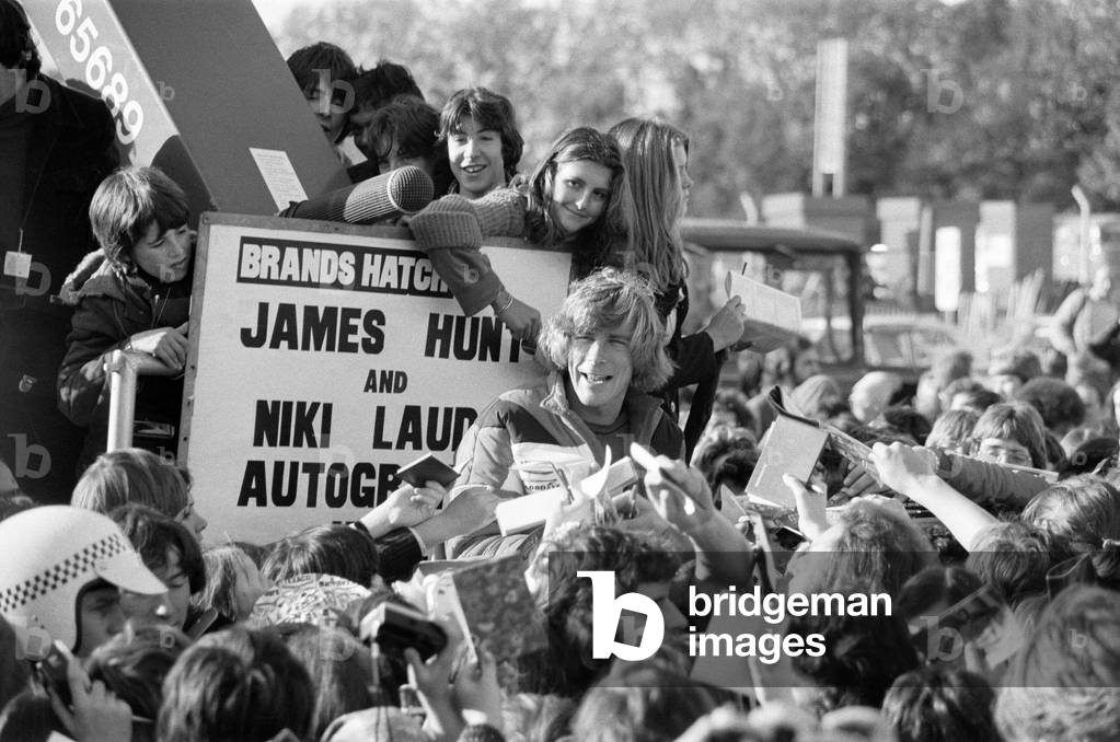 James Hunt and Nikki Lauda get trapped by fans at Brands Hatch. Only James Hunt made it to the autograph point. 8th November 1976 (b/w photo)