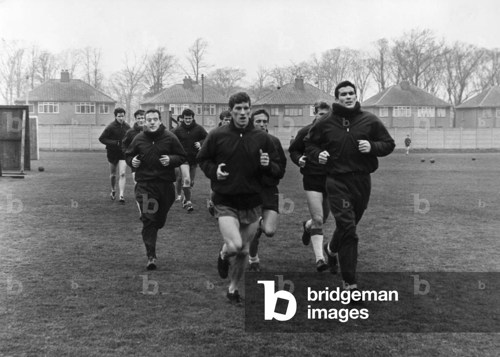 Liverpool team training session at Melwood February 1965. The team are led by Ron Yeats and Willy Stevenson, with Ian St John on left (photo)