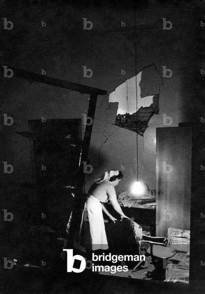 Nurse searching a blasted room during World War two. September 1944 P012282