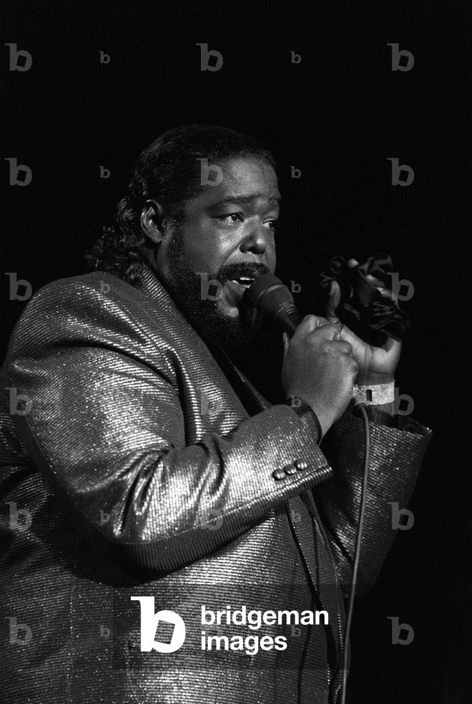 American singer songwriter Barry White performing in concert, December 1988 (b/w photo)