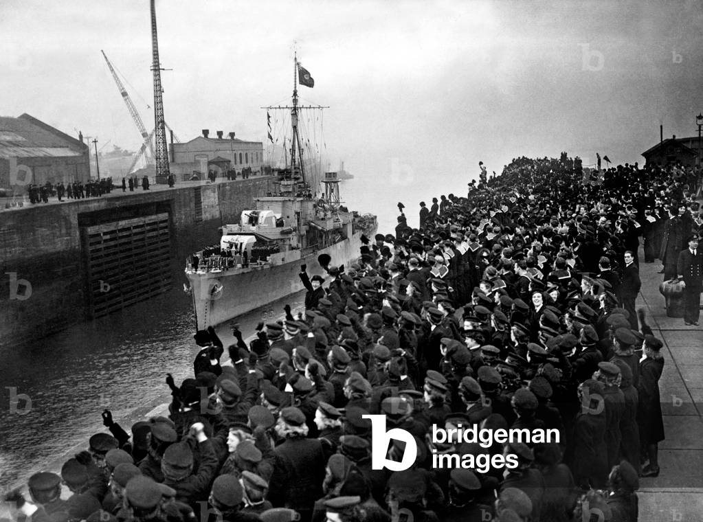 Cheering sailors and Wrens of the Royal Navy line the entrance to Gladstone dock in Bootle, Liverpool to celebrate the arrival of the U-boat destroyer Captain Frederick John Walker on board HMS Stork 
 January 1942