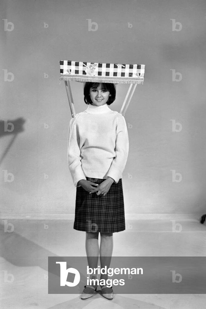 Therese Howard Jones demonstrating the wear-me umbrella. Model, c. 1959 (b/w photo)