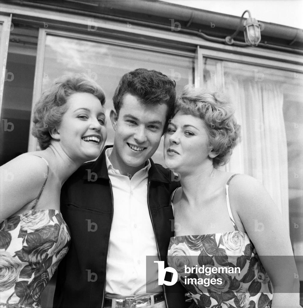 Singer Julian had two admirers in the Tyne-Tees Television studios during rehearsals for a show. June 1960