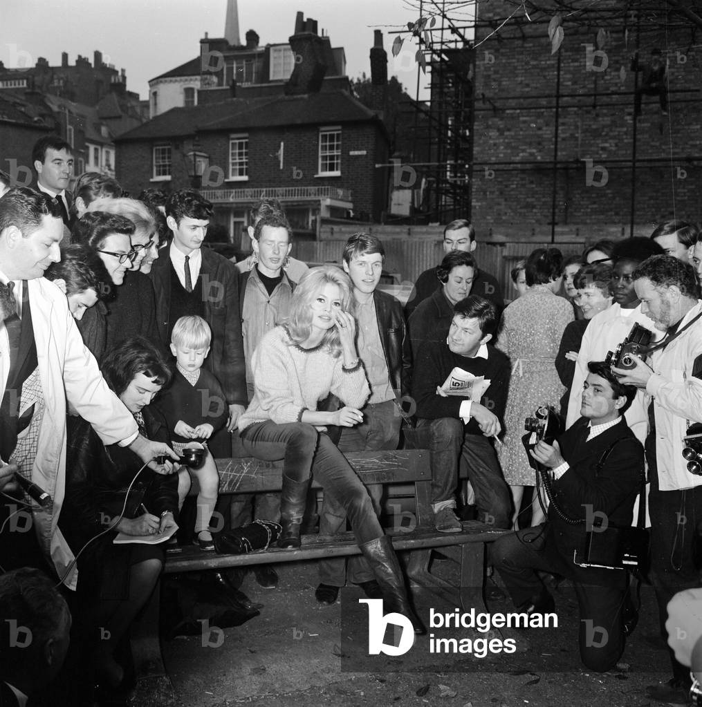Brigitte Bardot surrounded by fans & admirer, London, 1963 (b/w photo)