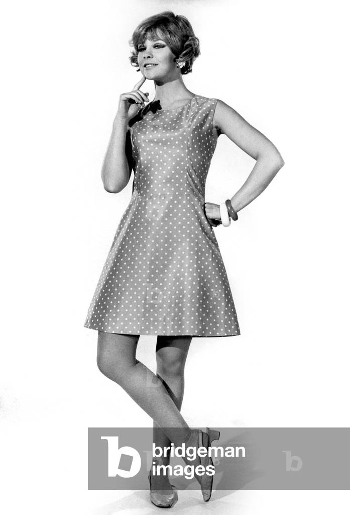 Model Marilyn Rickard wearing a sleeveless dress in sky blue cotton with white confetti spots, April 1968 (b/w photo)