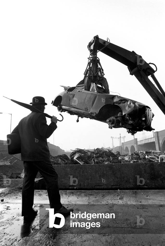 Man Scraps Jaguar Car: On the other hand, Sales Director Mr. Graham Parkes, who says he can no longer afford to run his 15 mile per gallon Jaguar, and was disgusted at dealers' offers, decided to watch its destruction, February 1975