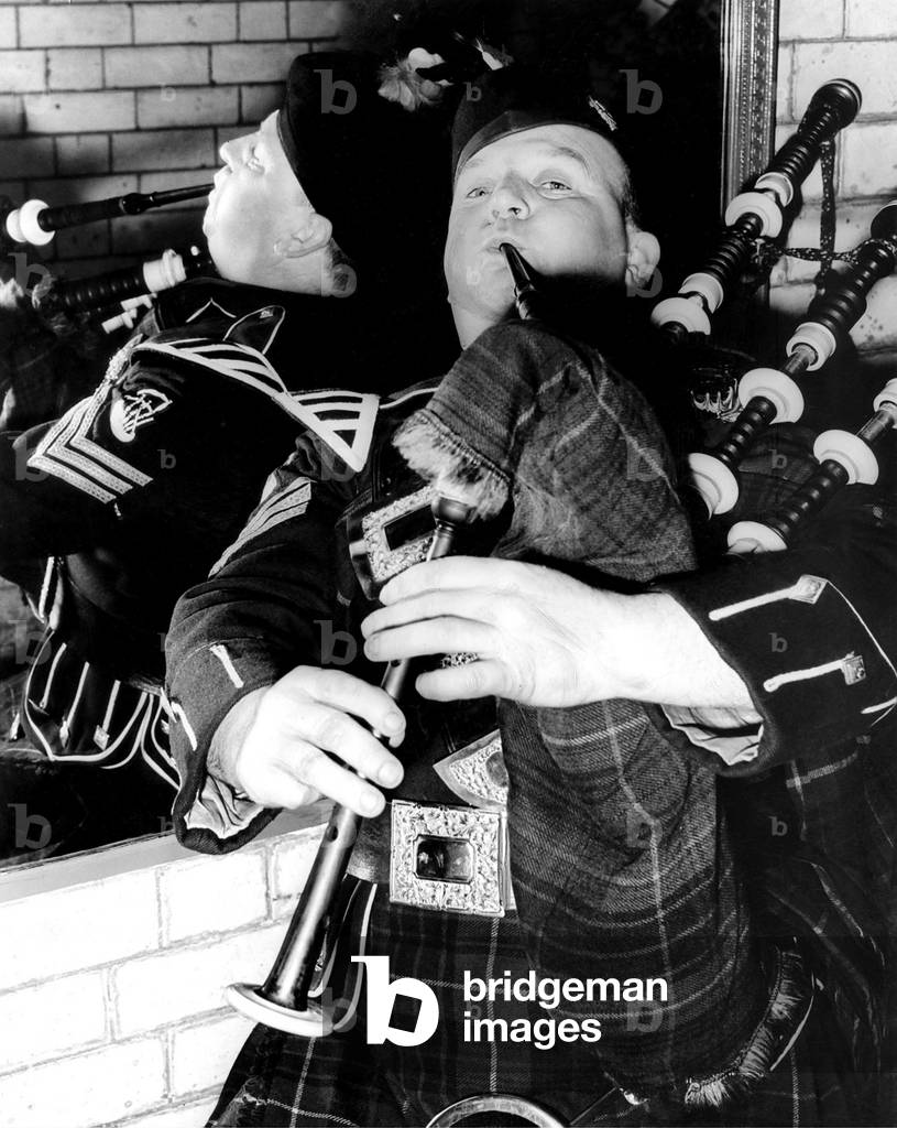 Thomas McPhail, of the City of Newcastle Pipe Band was blowing double at the miniature pipe band contest in the drill hall of the Tyneside Scottish, in Newcastle in March 1961. 25th March 1961 (b/w photo)