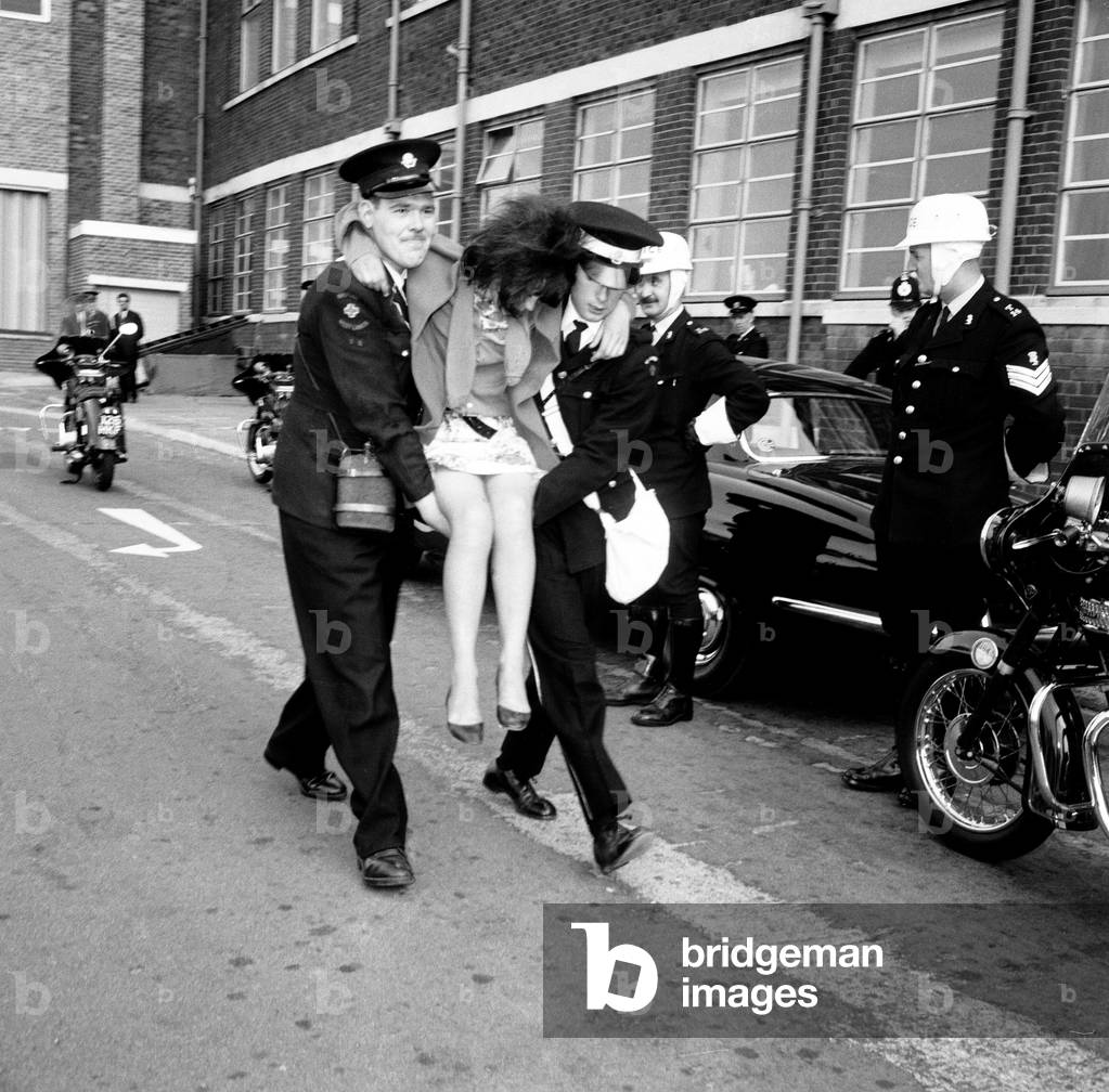Police try to control fans in the streets of Liverpool before the premiere of The Beatles film 