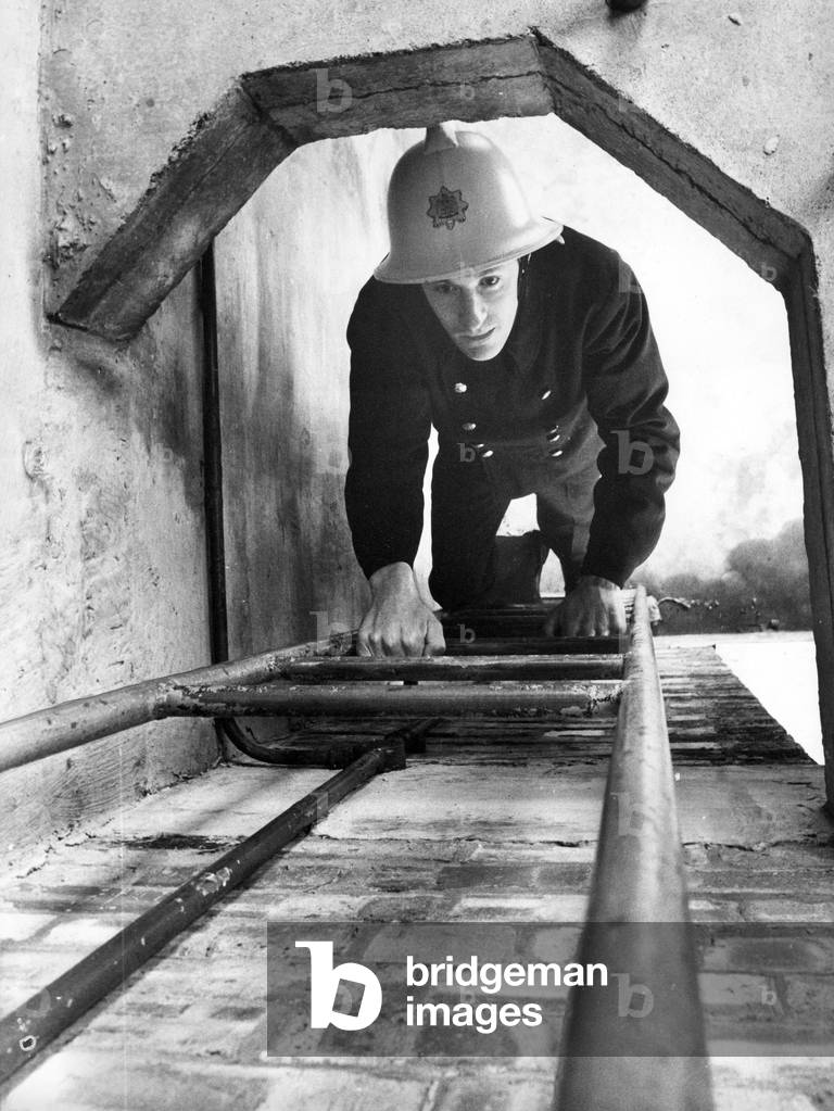 A firefighter climbs the ladder at the Morpeth drill tower where Northumberland firefighters are trained, 1970