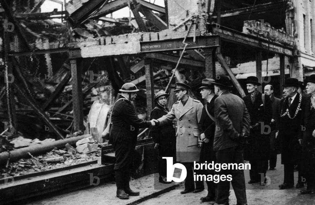 King George VI meets air raid wardens during his visit to the bomed damaged city of Bristol following an air raid, December 1940 (b/w photo)