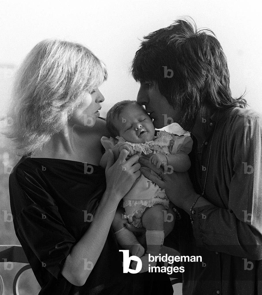 Ronnie Wood with his wife former model Jo Howard and their baby daughter Leah, 27th October 1978 (b/w photo)