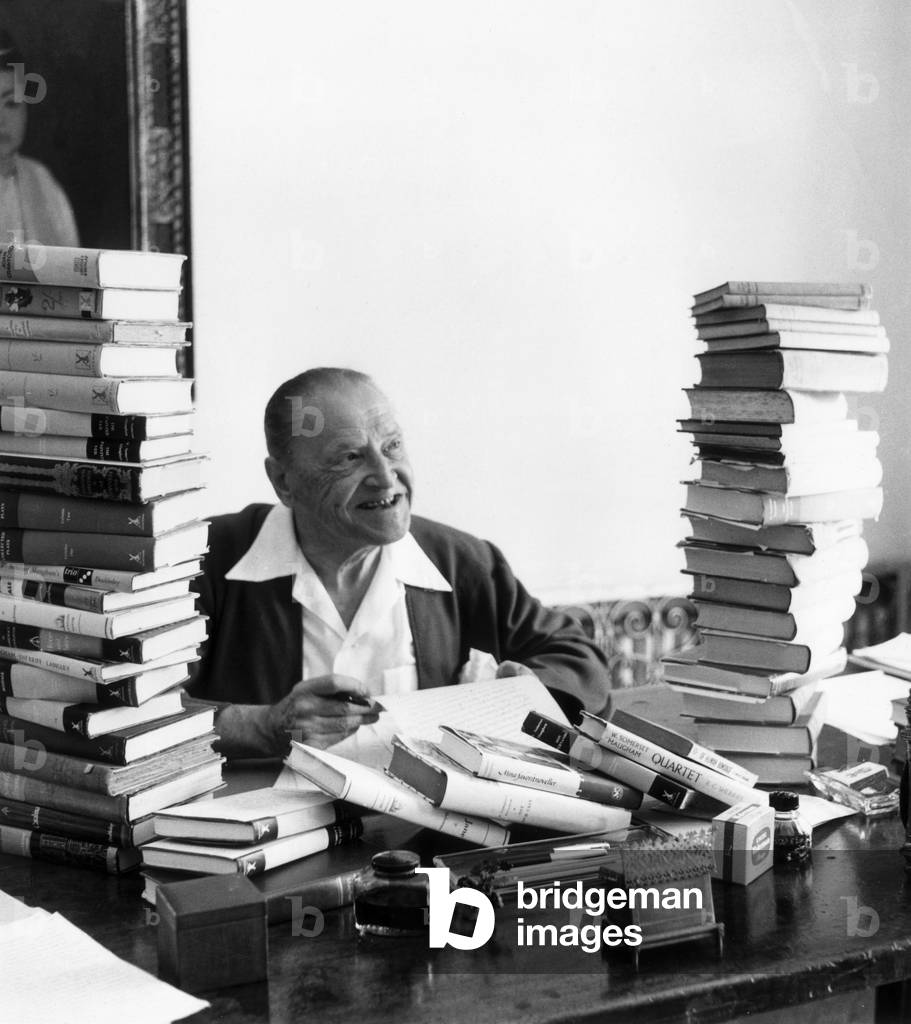 Somerset Maugham in his 'den' with a lifetime's work, 1954 (b/w photo)